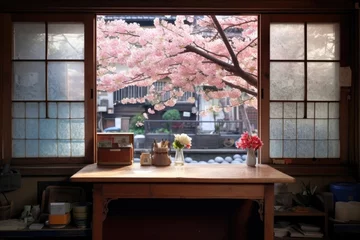 Foto op Canvas a window showing blooming cherry blossoms and a desk © Alfazet Chronicles