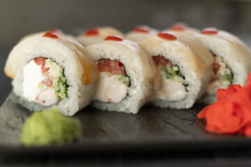 Sushi Rolls with shrimp, crab meat and cream cheese on black slate. Philadelphia roll sushi with shrimp. Sushi menu