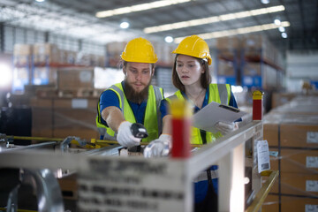 Warehouse staff verify automotive, paper items using handheld device, ensuring precise shipment. © SpaceOak