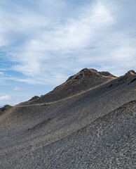 landforms of black mountain peaks on blue sky