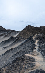 landforms of black mountain peaks which are like moon surfaces.