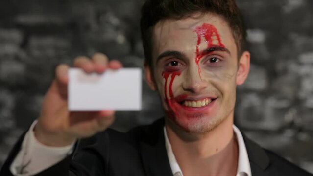 Male vampire gives you a business card