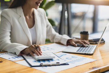 Female accountants calculating investments and analyzing charts in financial reports. Accounting and Financial Planning