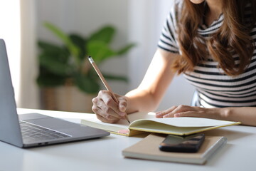 Woman studying online seminar on internet laptop.