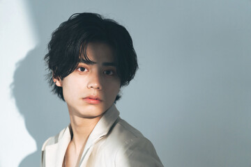 Beauty portrait of young Asian man with genderless makeup. Cosmetics and skin care concept.