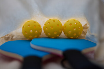 Rackets and ball for pickleball in a bag