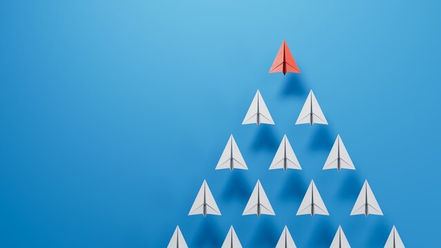 Leaderairplane concept. Red leader paper airplane leading among white on blue background. copy space.3D rendering on blue background.
