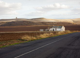 An abandoned country house in a region susceptible to drought. An arid landscape in the Seville...