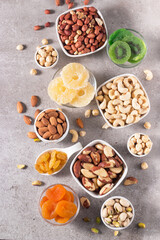 Healthy mix nuts and dried fruits on wooden background. Almonds, hazelnuts, cashews, peanuts, pistachios, Brazilian nuts