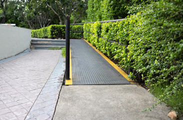 metal wheelchair ramps on pathway in park. Ramp way for disabled people at outdoor.