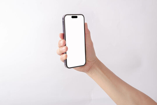 Hand holding mobile phone with blank screen on white background. Isolated.