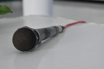 photo of a microphone lying on a white table