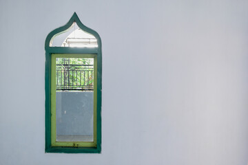 The photo of the window is at the edge of the frame, next to it is a blank white wall. Can be filled with words