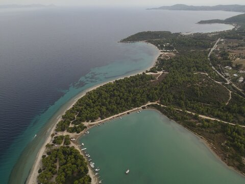 Overhead drone photo over the rocks and the tropical blue ocean of Toroni in Halkidiki, Greece