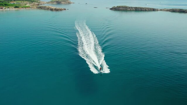 Aerial view of jet ski cruising in high speed in Adriatic Sea 