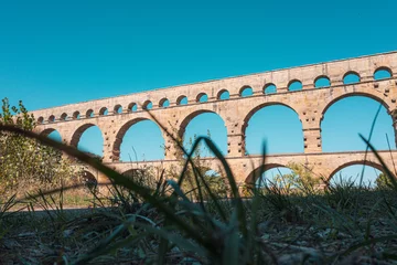 Fotobehang Pont du Gard Pont du Gard three-tiered aqueduct was built in Roman times on the river Gardon.