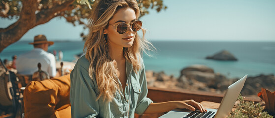 Dream office work concept of young millennial freelancing female working on laptop by the seaside,.