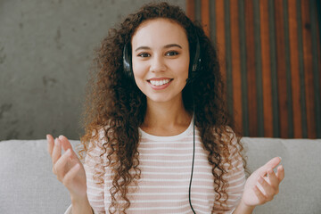 Happy employee operator business woman in set microphone headset for helpline assistance sit on on...
