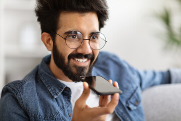 Young Smiling Indian Man Using Recording Voice Message On Smartphone