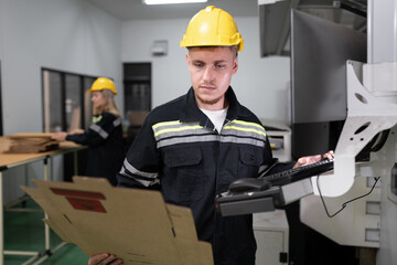 Technician caucasian man use computer control print machine and team working background at office	