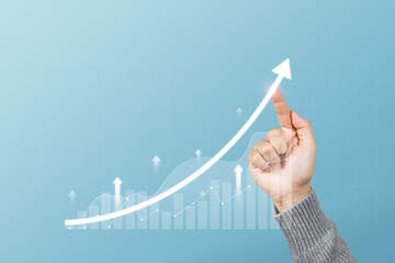 Hand touching arrows pointing up with graph as a symbol of growth and success or rising successful development and business development in the future