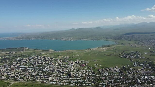 Aerial drone footage of Sevan Lake, Armenia, capturing its vast, tranquil waters and the picturesque surrounding landscape from above