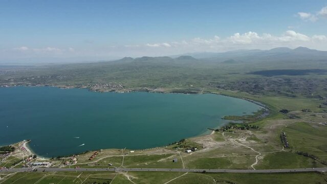 Aerial drone footage of Sevan Lake, Armenia, capturing its vast, tranquil waters and the picturesque surrounding landscape from above