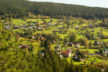 Aerial of a Ukrainian village in the Carpathians during sunny afternoon