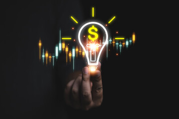 Business growth, advancement, financial success skills or success Businessman holds light bulb icon and money with graph Concept of financial growth, investment