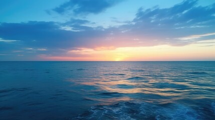 Fototapeta na wymiar sunset over the beautiful deep blue ocean
