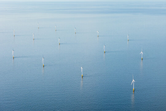 Aerial view of offshore wind farm with wind turbines or wind mills on the North Sea, The Netherlands, Europe.