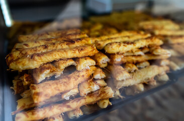 Puff pastry pie on display in a store window. Burek.