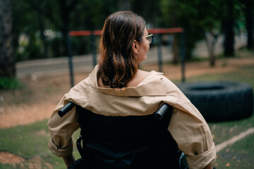 Woman with disability sitting in wheelchair in park