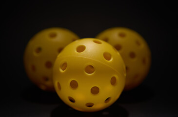 Set of yellow plastic balls for pickleball game