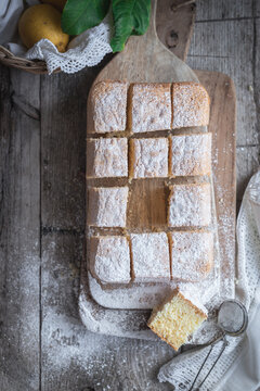 Pasiego cake sprinkled with sugar on rustic wooden table