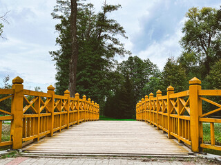 wooden bridge in the park - obrazy, fototapety, plakaty