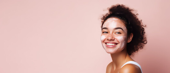 Happy young Woman closeup face with cosmetic cream smudges isolated on flat pink background with copy space, banner template. 
