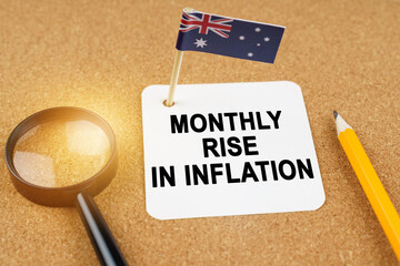 On the table is the flag of Australia and a sheet of paper with the inscription - monthly rise in...