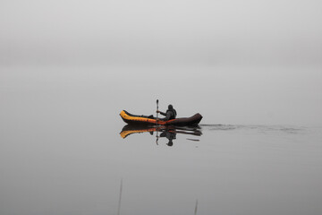 Fototapeta premium paddle boating in misty lake