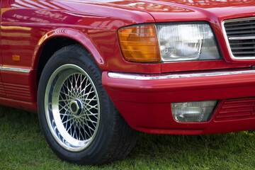 close-up detaild of a vintage retro car headlight and wheel rim