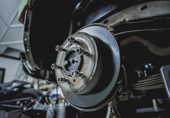 Replacing spare parts on a disassembled car in a car service garage