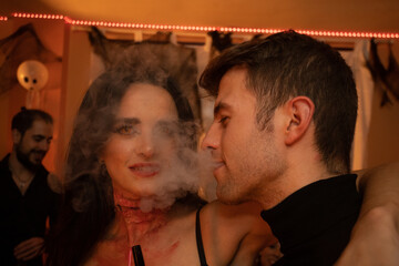 European Halloween party in a friends apartment- -Images of Young adults celebrating Halloween. The...