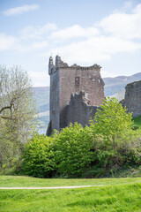 Fototapeta na wymiar Tower of Urquhart Castle, Loch ness lake in the background, vertical shot, Scotland