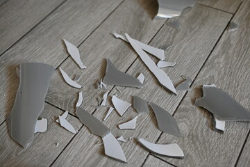 glass shards on the floor as a backdrop, broken dishes grey as a backdrop