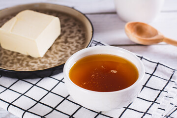 Fragrant melted brown butter for sauce in a bowl on the table