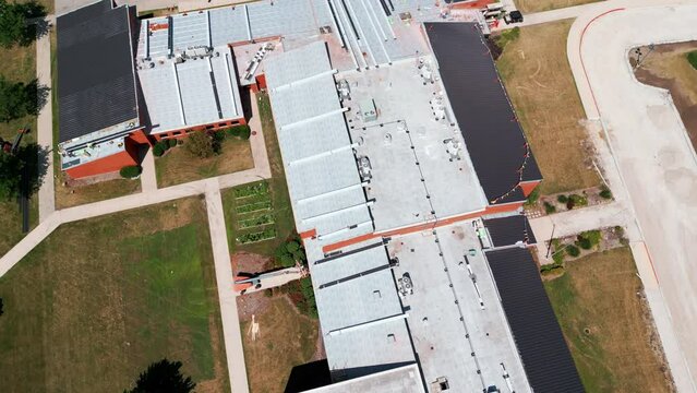Drone shot of an industrial roof, Roofers installing a new roof on an industrial building. Above view footage