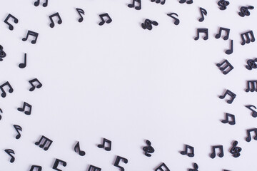 Musical concept frame of black notes on a light background copy space