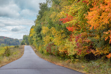 Rolling country backroads during autumn with brilliant fall colors near Chippewa Falls Wisconsin