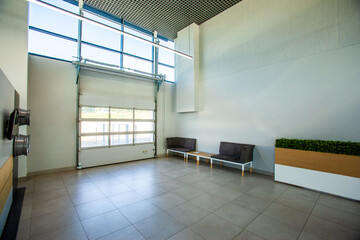Empty place for issuing new cars in a dealership with roller gates