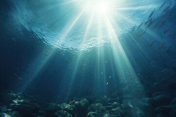 Underwater background of shafts of light coming through surface, illuminating the bottom of the Sea - obrazy, fototapety, plakaty